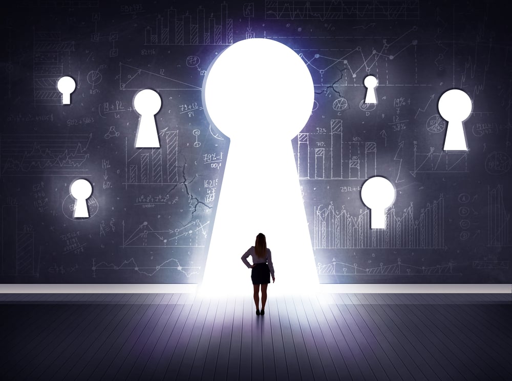 Successful businessman looking through keyhole Successful businessman looking through keyhole